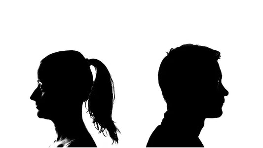 a shadow of a man and a woman turned away from each other in conflict