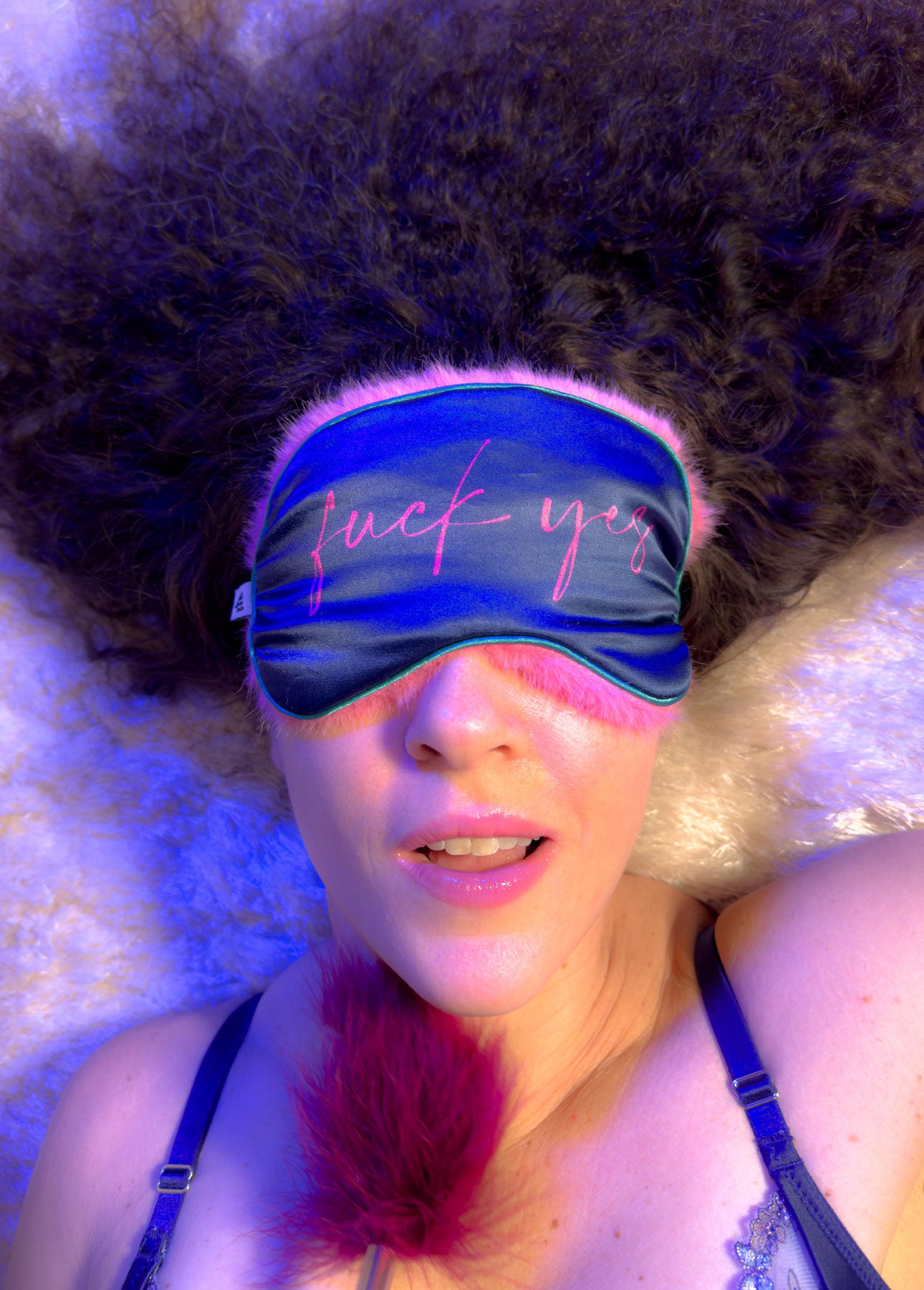 Actions Peak Louder satin and fur sensual blindfold worn by woman - blue pink BDSM eye mask